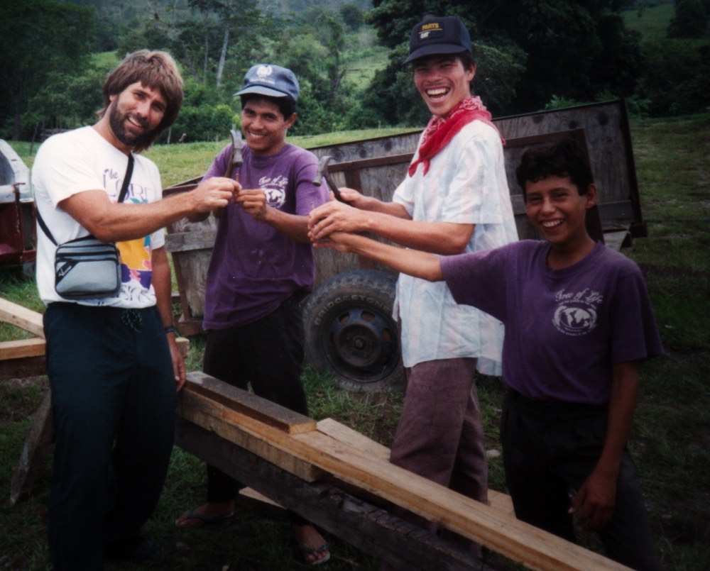 Rafael holding a nail over wood framework 